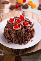 Delicious Chocolate Cake with Rich Toppings and Red Cherries