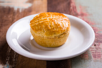 Golden Homemade Pastry on White Plate in Rustic Setting