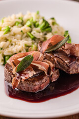 Gourmet Dish Saltimbocca Featuring Grilled Meat With Herb Garnish and Rice