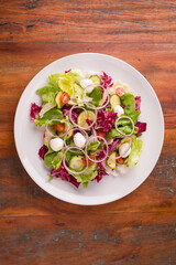Fresh Colorful Salad with Mozzarella and Vegetables on Wooden Table