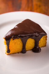 Delicious Chocolate-Glazed Cake Slice on a White Plate