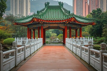 Fototapeta premium A red and green pagoda with a white bridge leading to it in a Chinese garden.