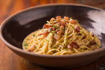Delicious Spaghetti Carbonara in Rustic Bowl on Wooden Table