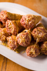 Delicious Sausage-Stuffed Pastry Cones on Elegant White Plate