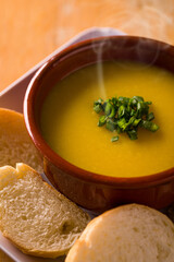 Warm Bowl of Soup with Fresh Garnish and Bread Slices