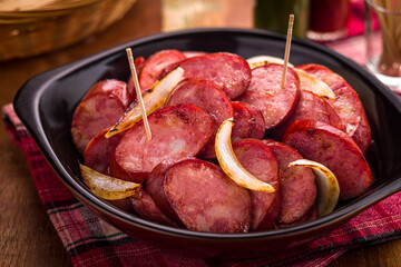 Delicious Calabresa Sausage with Onions on a Rustic Plate