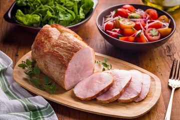 Sliced Roasted Pork with Fresh Salad on Wooden Table