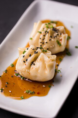 Delicious Steamed Dumplings With Soy Sauce and Sesame Seeds