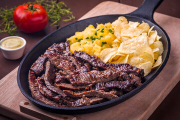 Delicious Grilled Beef Strips Served with Potatoes and Chips