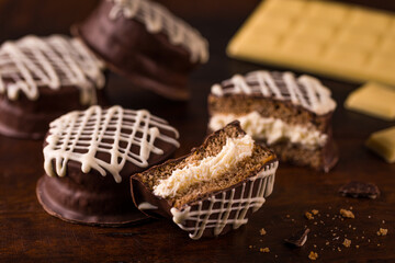 Close-Up of Chocolate Alfajores with Cream Filling and White Drizzle