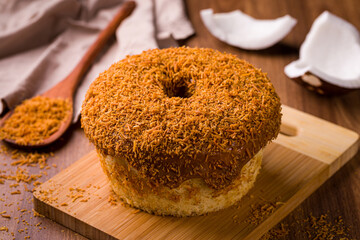 Delicious Coconut Cake With Caramel Icing on Wooden Board