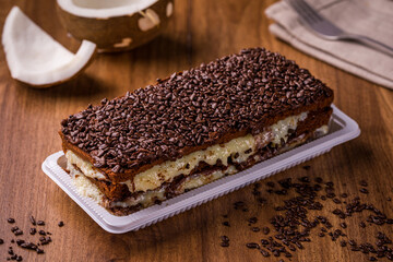 Delicious Chocolate Coconut Cake with Sprinkles on Wooden Table
