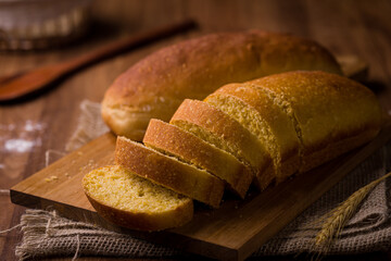Freshly Baked Sliced Bread on Rustic Wooden Cutting Board