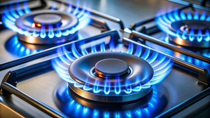 Close up of a modern gas stove with blue flames burning on the burners
