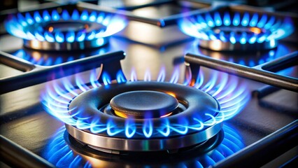 Close up of a modern gas stove with blue flames burning on the burners