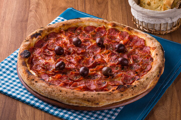 Delicious Pepperoni Pizza with Olives on a Checkered Tablecloth