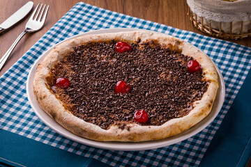 Delicious Chocolate Dessert Pizza With Cherries On Checkered Towel
