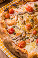Close-Up of Delicious Homemade Pizza with Anchovies and Cherry Tomatoes
