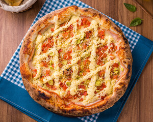 Delicious Homemade Pizza with Cheese and Fresh Veggies on Wooden Table