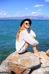 Autumn portrait of happy smiling young woman wearing a sweater and hat. 