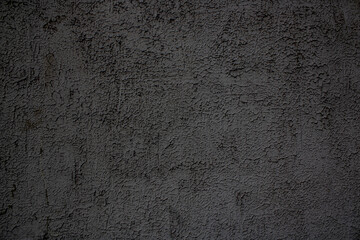 This is a detailed close-up of a grey or black wall full of tiny dots on it