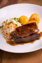 Gourmet Braised Beef with Rice and Vegetables on White Plate