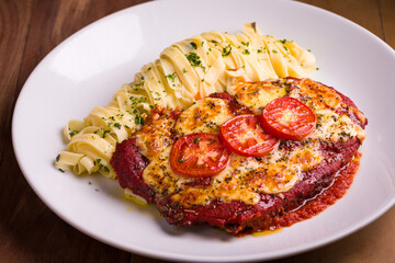 Delicious Chicken Parmesan with Fettuccine Pasta in White Plate