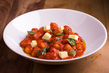 Delicious Italian Gnocchi with Tomato Sauce and Basil Garnish