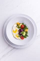 Fresh Vegetable Salad With Cheese and Olive Oil on White Plate