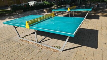Outdoor ping pong table in a sunlit park setting
