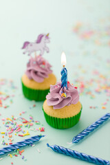 Colorful Unicorn Birthday Cupcakes With Lit Candle