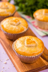 Delicious Homemade Pies with Heart Shaped Topping on Wooden Board