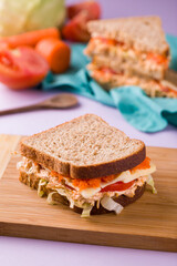 Delicious Homemade Sandwich with Fresh Vegetables on a Wooden Board