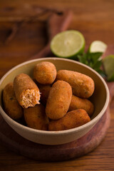 Delicious Golden Croquettes in Rustic Bowl With Fresh Lime