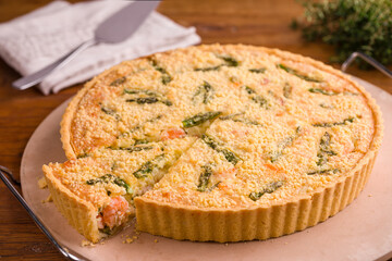 Delicious Homemade Quiche with Asparagus and Cheese on Wooden Table