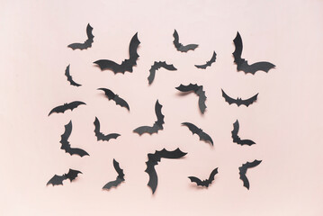 Paper bats for Halloween party on pink background