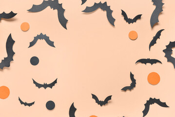Frame made of paper bats for Halloween party on orange background