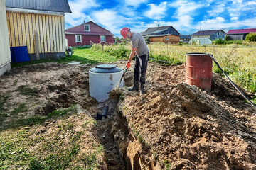 Worker buries an absorbent trench of wastewater disposal area of rural domestic sewage system.