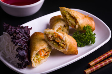Delicious Crispy Spring Rolls on White Plate with Fresh Garnish