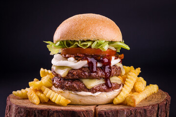 Delicious Double Cheeseburger With Crinkle Fries on Wooden Board