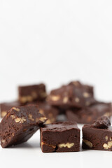Close Up of Homemade Chocolate Pecan Fudge on a White Background