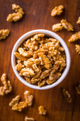 Bowl of Fresh Walnuts on Rustic Wooden Table Surface