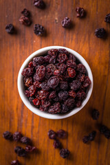 Top View of Bowl with Dried Raisins on Wooden Table