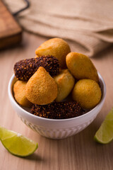 Delicious Assorted Brazilian Snacks in a White Bowl on Table