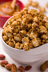 Delicious Gourmet Caramel Popcorn in White Bowl with Peanuts