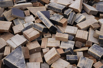 Pile of weathered wooden blocks in various shapes and sizes. Background or backdrop