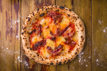 Delicious Wood-Fired Pizza with Crispy Bacon Toppings on Rustic Surface