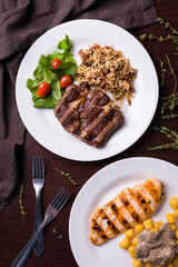 Delicious Grilled Steak and Chicken with Rice and Vegetables on Plates