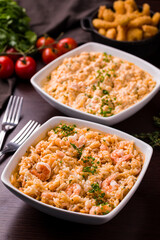 Delicious Shrimp Rice Dish with Fresh Vegetables and Fried Calamari