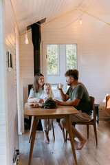 Family breakfast with coffee, croissants, and fruit in cozy, minimalist home, sharing joyful moments